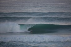 Heath Ratten bottom turns into a large, hollow wave at St Kilda Beach, Dunedin, New Zealand.