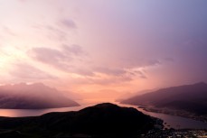 Sunset as weather arrives over Lake Wakatipu and Queenstown, Central Otago, New Zealand.