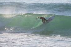 A surfer turns on a wave at St Clair Beach, Dunedin, New Zealand. 