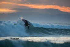 Simon Dickie boosts on a wave at Blackhead Beach, Dunedin, New Zealand. 