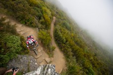 Justin Leov gets loose on the rocky staircase at the top of the Mt Cargill trail during stage 3 of the 2013 Urge 3 Peaks Enduro held in Dunedin, New Zealand.