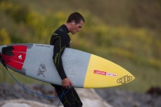 Josh Thickpenny enters the water at Blackhead Beach, Dunedin, New Zealand. 