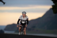 Pro cycling athlete Alison Shanks riding on the Otago Peninsula roads (voted top 10 cycling routes in the world by Lonely Planet), Dunedin, New Zealand.