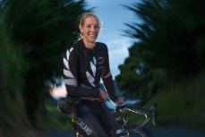 Pro cycling athlete Alison Shanks riding on the Otago Peninsula roads (voted top 10 cycling routes in the world by Lonely Planet), Dunedin, New Zealand.