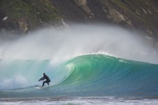 Davey rides a clean, hollow wave at a secluded bay in the Catlins, Otago, New Zealand. 