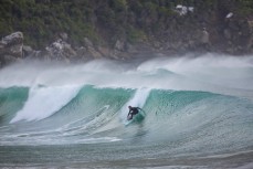Dunedin artist Simon Kaan rides a clean, hollow wave at a secluded bay in the Catlins, Otago, New Zealand. 