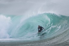 Dunedin artist Simon Kaan rides a clean, hollow wave at a secluded bay in the Catlins, Otago, New Zealand. 