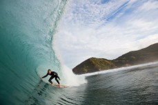 Aaron Morrison rides a barrel during a surf at a beach in Raglan, Waikato, New Zealand. 