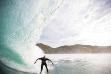 Lyndon Green pauses for a barrel section during a surf at a beach in Raglan, Waikato, New Zealand. 