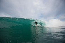 Ben rides a barreling wave during a surf at a beach in Raglan, Waikato, New Zealand. 