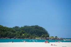 Sunbathers make the most of the sunshine on the main Beach at Mount Maunganui, Bay of Plenty, New Zealand. 