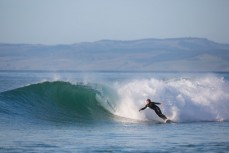 James Steiner bottom turns on a punchy wave at Blackhead Beach, Dunedin, New Zealand. 