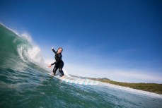 Hannah Joynt rides a wave at Blackhead Beach, Dunedin, New Zealand. 