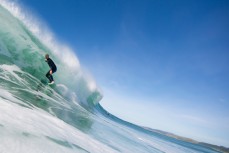 Simon Dickie puts his hand in the wall to stall for a barrel at Blackhead Beach, Dunedin, New Zealand. 