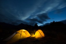Tents glow in the dusk light at 12 Mile Delta near Queenstown, New Zealand. 