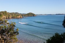 Surfers at Sandy Bay, Northland, New Zealand.