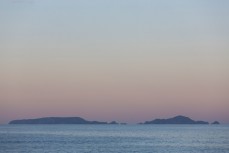 Sunset hues across the Poor Knights Islands 23km off the Tutukaka Coastline, Northland, New Zealand.