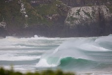 A wave breaks on a remote beach in the Catlins, Dunedin, New Zealand. 