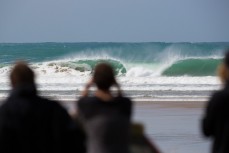 Mates watch as a wave breaks on a remote beach in the Catlins, Dunedin, New Zealand. 