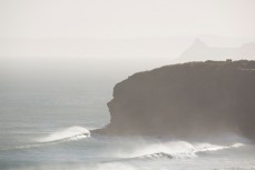 Surfers paddle into the lineup of a city beach, Dunedin, New Zealand. 