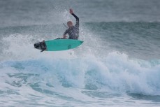 Simon Dickie airs in playful waves at Blackhead Beach, Dunedin, New Zealand. 