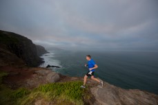 Ultra distance trail runner Glenn Sutton during an early morning training run on the Karetai Track, Dunedin, New Zealand. 