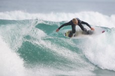 A surfer rides a lip at St Kilda Beach, Dunedin, New Zealand. 
