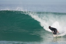 Brook Jenkins bottom-turns on a wave at St Kilda Beach, Dunedin, New Zealand. 