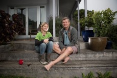 Paul and Shelley Hersey sit on their "worry-free" steps at their home in Warrington, Dunedin, New Zealand. 