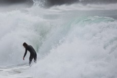 Surfers revel in playful conditions at Whareakeake, Dunedin, New Zealand. 