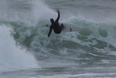 Sam Guthrie turns in the lip in playful conditions at Blackhead Beach, Dunedin, New Zealand. 