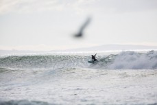 Surfers enjoy offshore conditions at Aramoana, Dunedin, New Zealand. 
