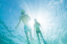 Aaron Gallagher and Robyn MacFarlane skin dive at Sharkfin Bay on Fitzroy Island near Cairns in Tropical North Queensland, Queensland, Australia. 