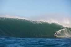 James Steiner rides a large set wave at a remote reef break near Dunedin, New Zealand. 