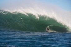James Steiner rides inside a large set wave at a remote reef break near Dunedin, New Zealand. 