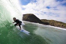 Brett Wood rides a wave at a beachbreak near Raglan, New Zealand. 