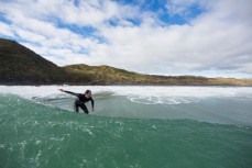 Brett Wood rides a wave at a beachbreak near Raglan, New Zealand. 