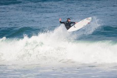 Tom Bracegirdle airs on a fun, glassy day at Poles, St Clair Beach, Dunedin, New Zealand. 