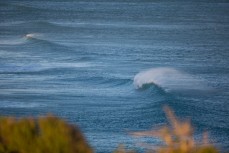 A wave breaks at Tomahawk Beach, Dunedin, New Zealand. 