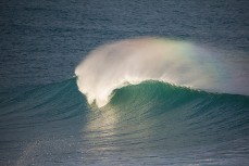 A rainbow appears as a wave breaks at St Clair Beach, Dunedin, New Zealand. 