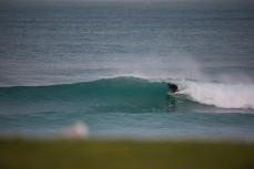 A surfer rides a tube on a wave at St Clair Beach, Dunedin, New Zealand. 