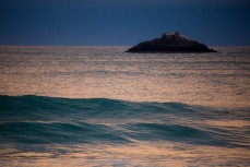 Swell lines wander into St Clair Beach, Dunedin, New Zealand at dusk. 