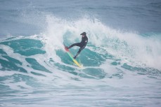 Craig Higgins turns on a fro0thy wave at Blackhead Beach, Dunedin, New Zealand. 