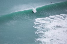 A surfer takes off ona wave shortly after the offshore arrived at Aramoana, Dunedin, New Zealand. 