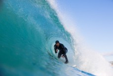 Davy Wooffindin gets tubed in clean surf conditions at Aramoana Beach, Dunedin, New Zealand. 