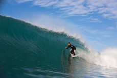 A surfer gets barrelled in clean surf conditions at Aramoana Beach, Dunedin, New Zealand. 