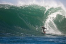 James Steiner rides a solid wave on a remote reef break near Dunedin, New Zealand. 
