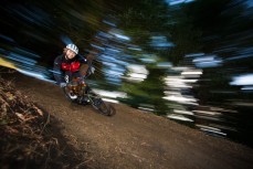 James Walter rides a berm in the trees at Skyline Rotorua, Rotorua, New Zealand. 