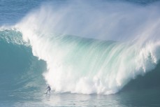 Nick Smart rides a large wave at a reef break in the Catlins, Southland, New Zealand. 