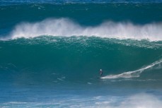 Brad Roberts rides a large wave at a large reef break in the Catlins, Southland, New Zealand. 